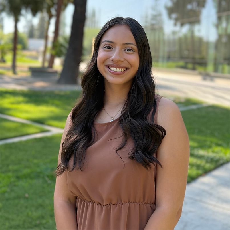 Advisor, Briana Rosales, standing in front of the Fresno State library.