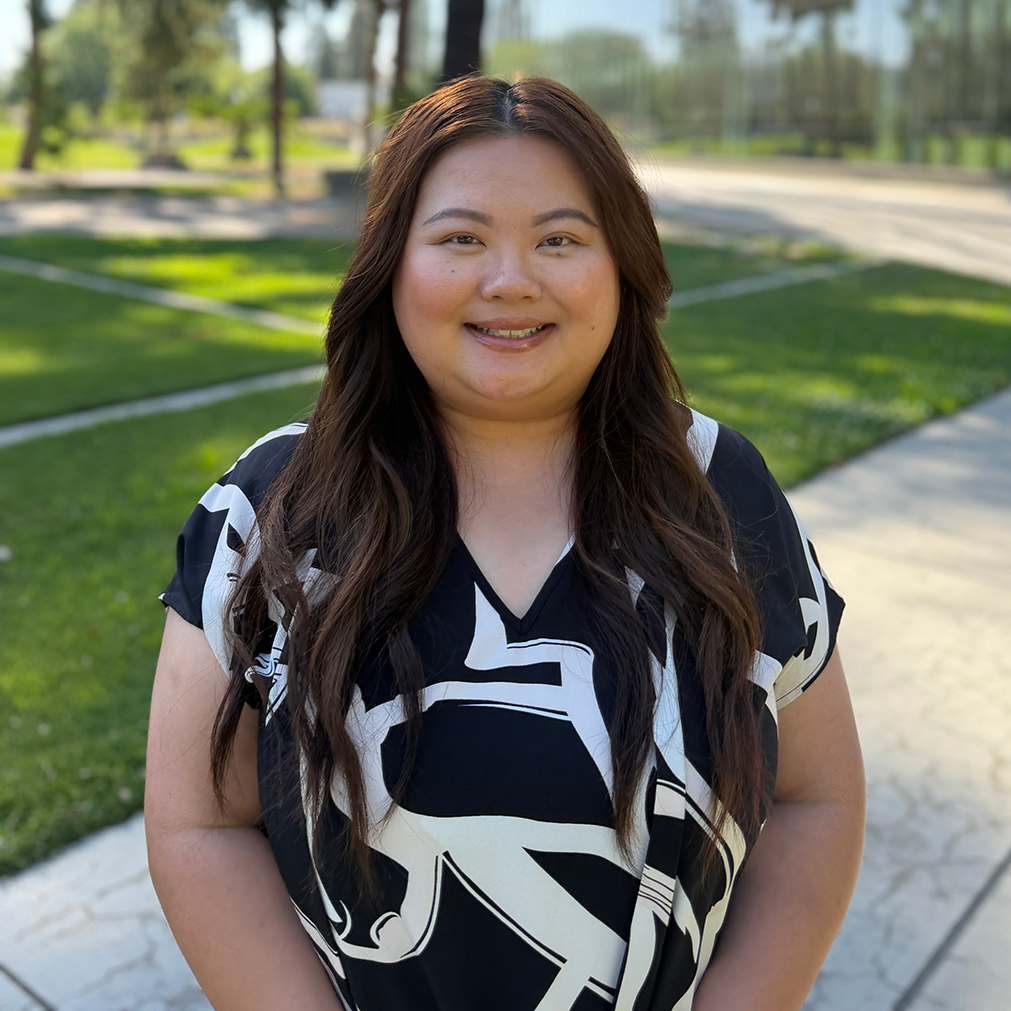 Advisor, Lisa Vang, standing in front of the Fresno State library.