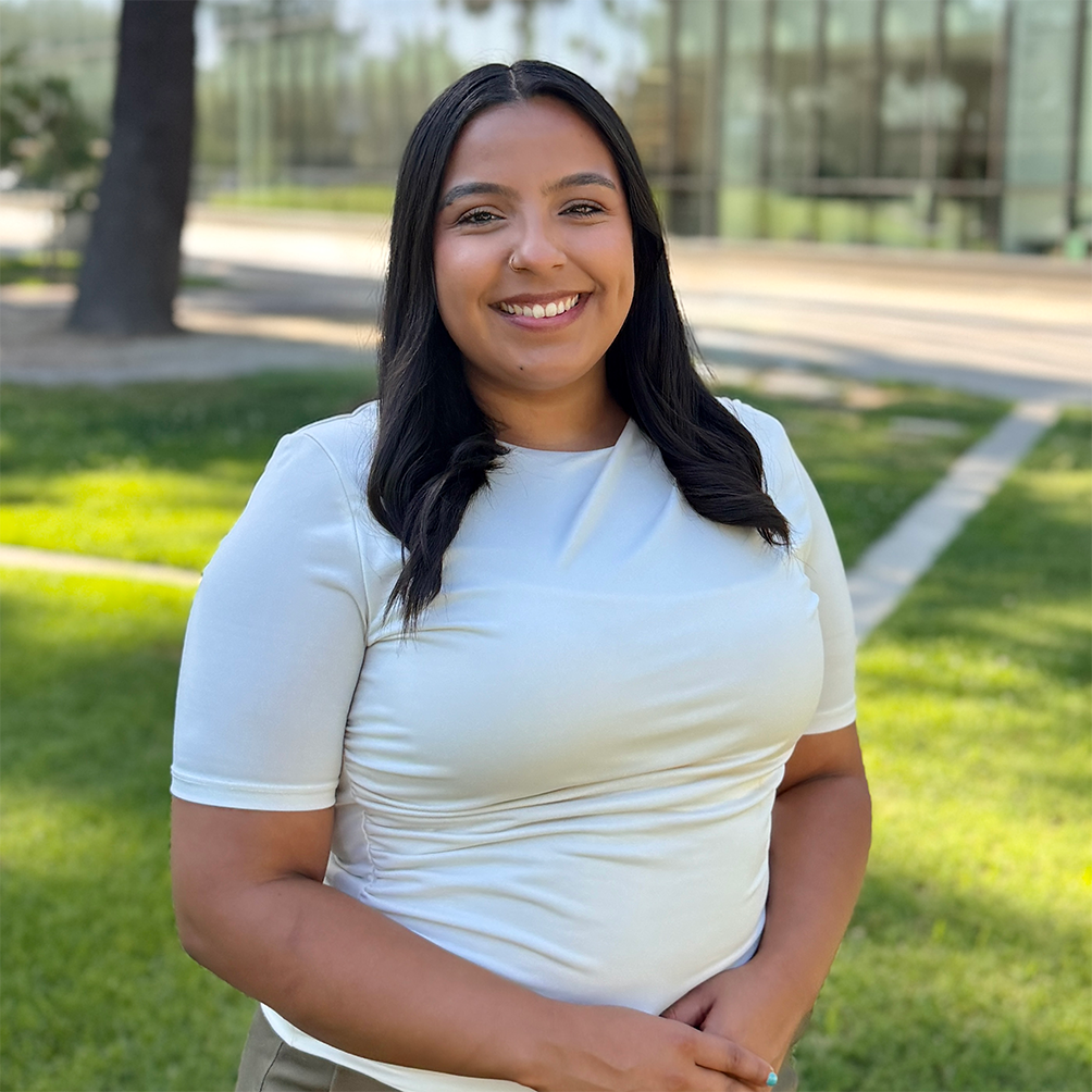 Advisor, Lucero Mendoza, standing in front of the Fresno State library.