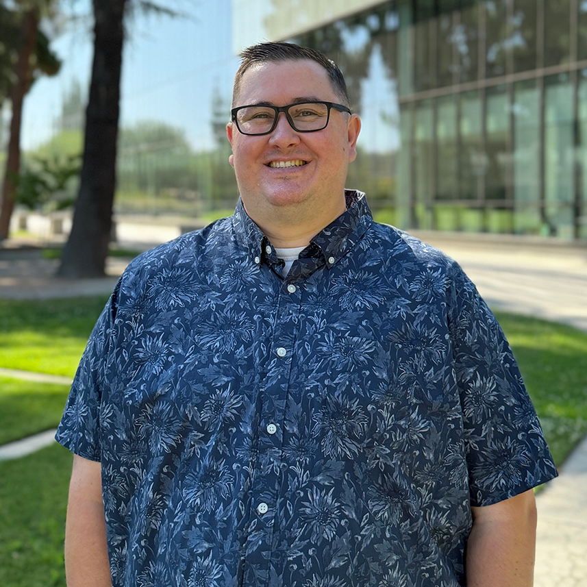 Advisor, Ross Whitton, standing in front of the Fresno State library.