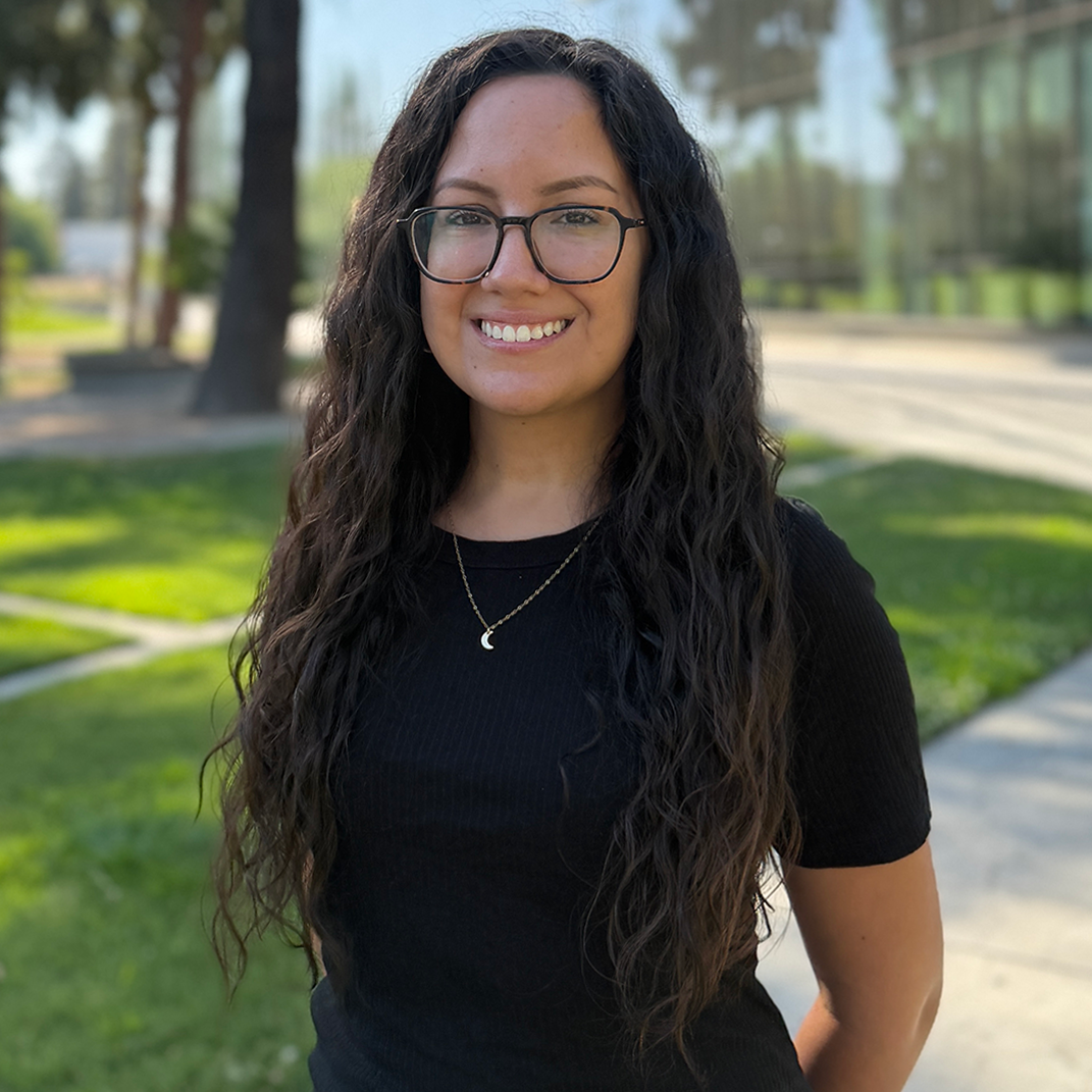 Sonya Headshot Advisor, Sonya Peña, standing in front of the Fresno State library.