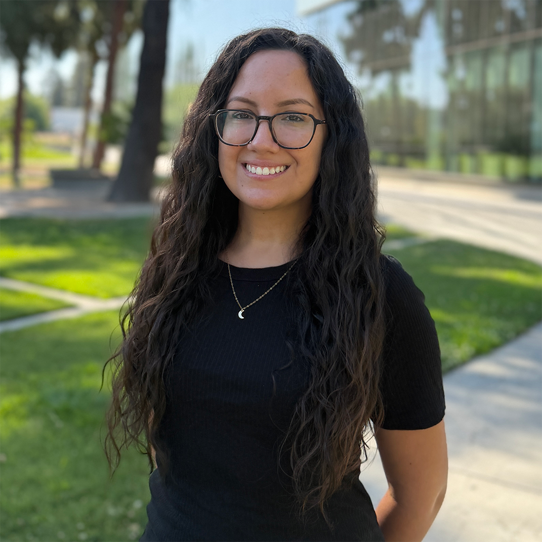 Advisor, Sonya Peña, standing in front of the Fresno State library.