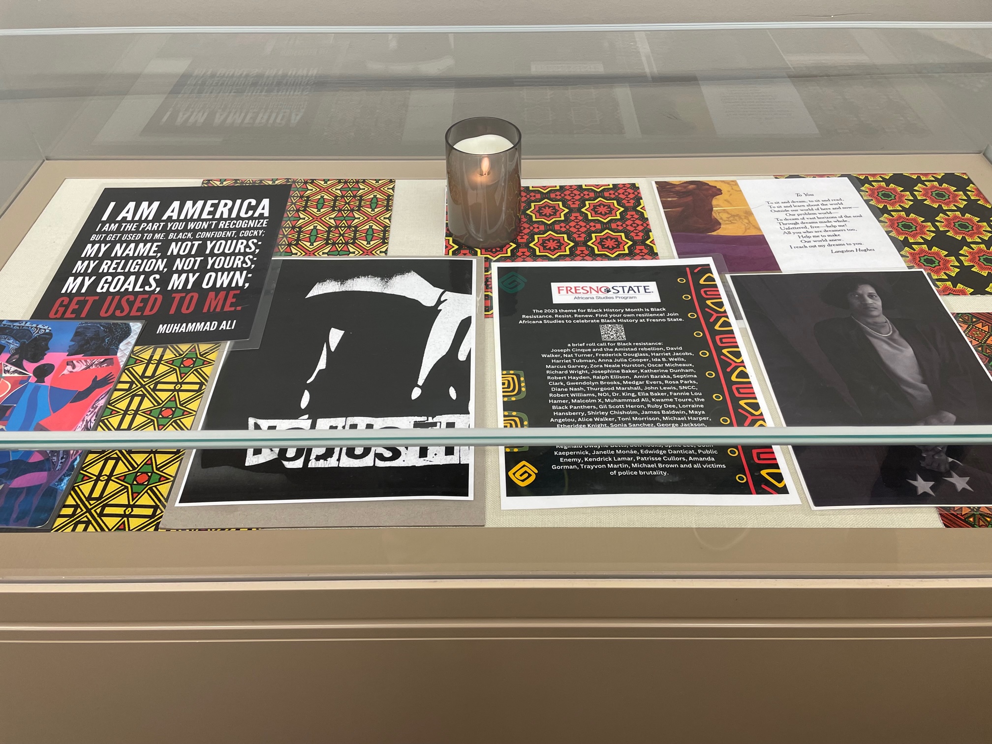 Photo of Black History Month display case featuring various photos and African inspired patterns.
