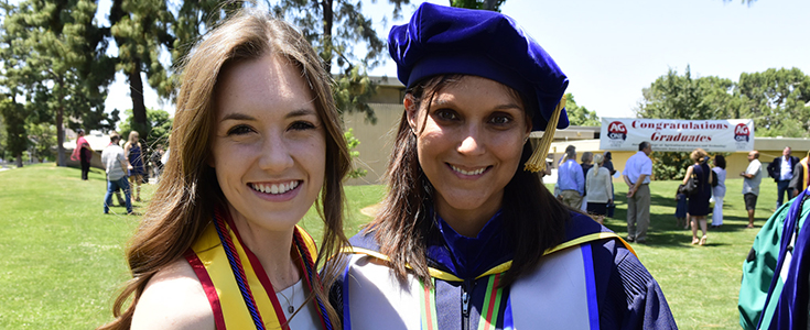 Two People Wearing Commencement Robes