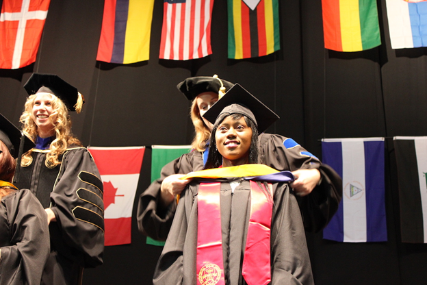 Graduate student receiving her graduate hood at graduation