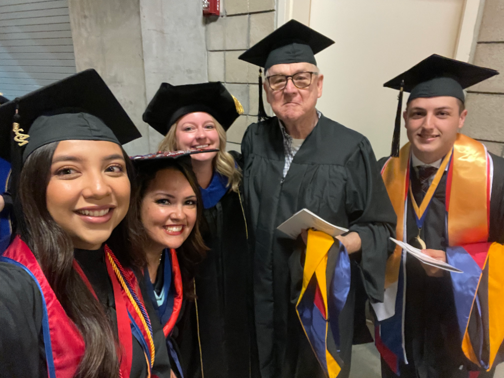 Graduate students at commencement receiving their diplomas