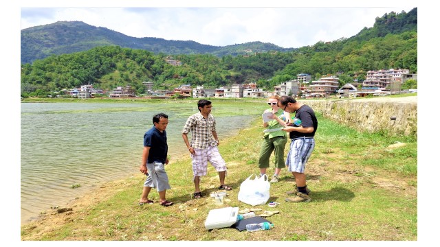 U.S. and Nepali students and Dangi evaluate water quality of Phewa Lake in Nepal.