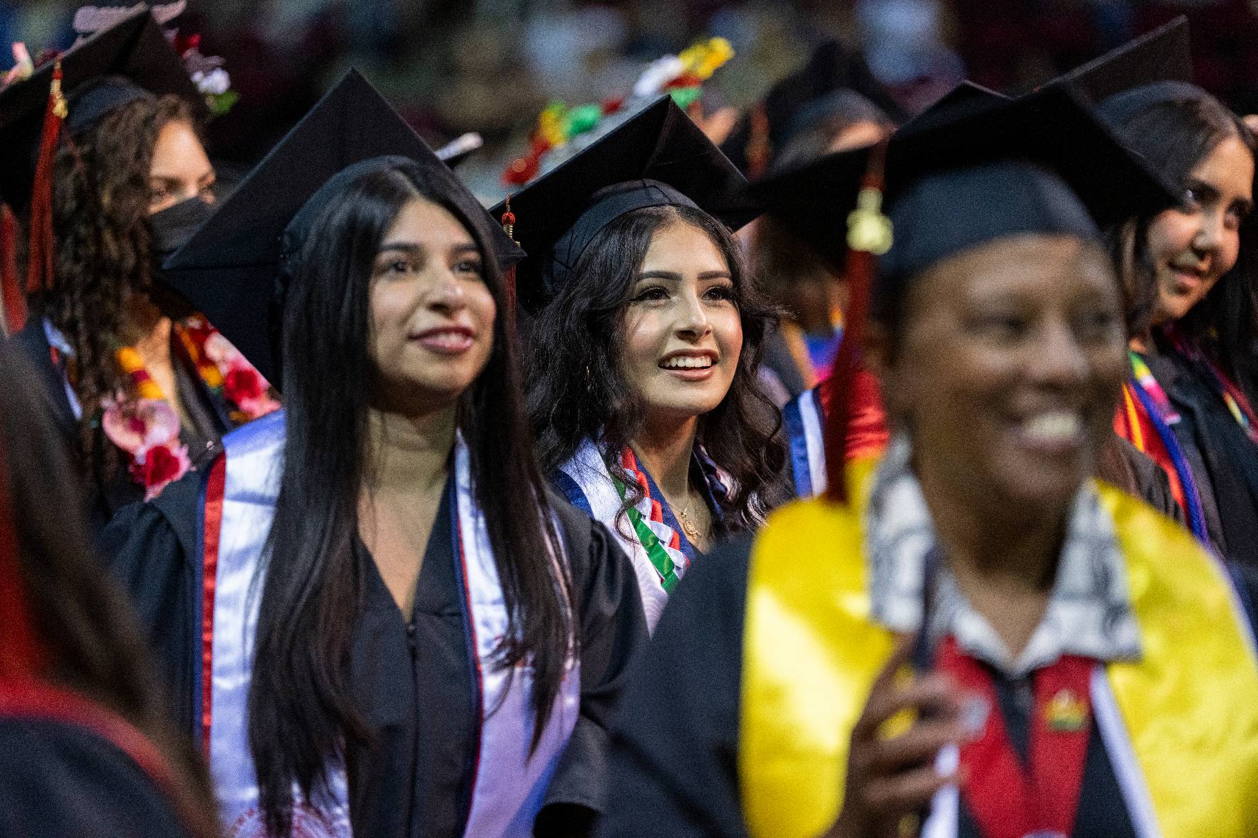 A group of  commencement students standing during the college ceremony