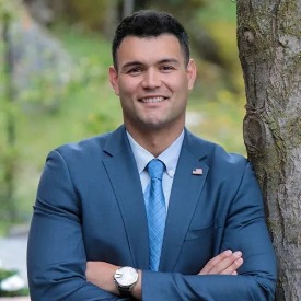 Assemblymember David Tangipa leaning against a tree